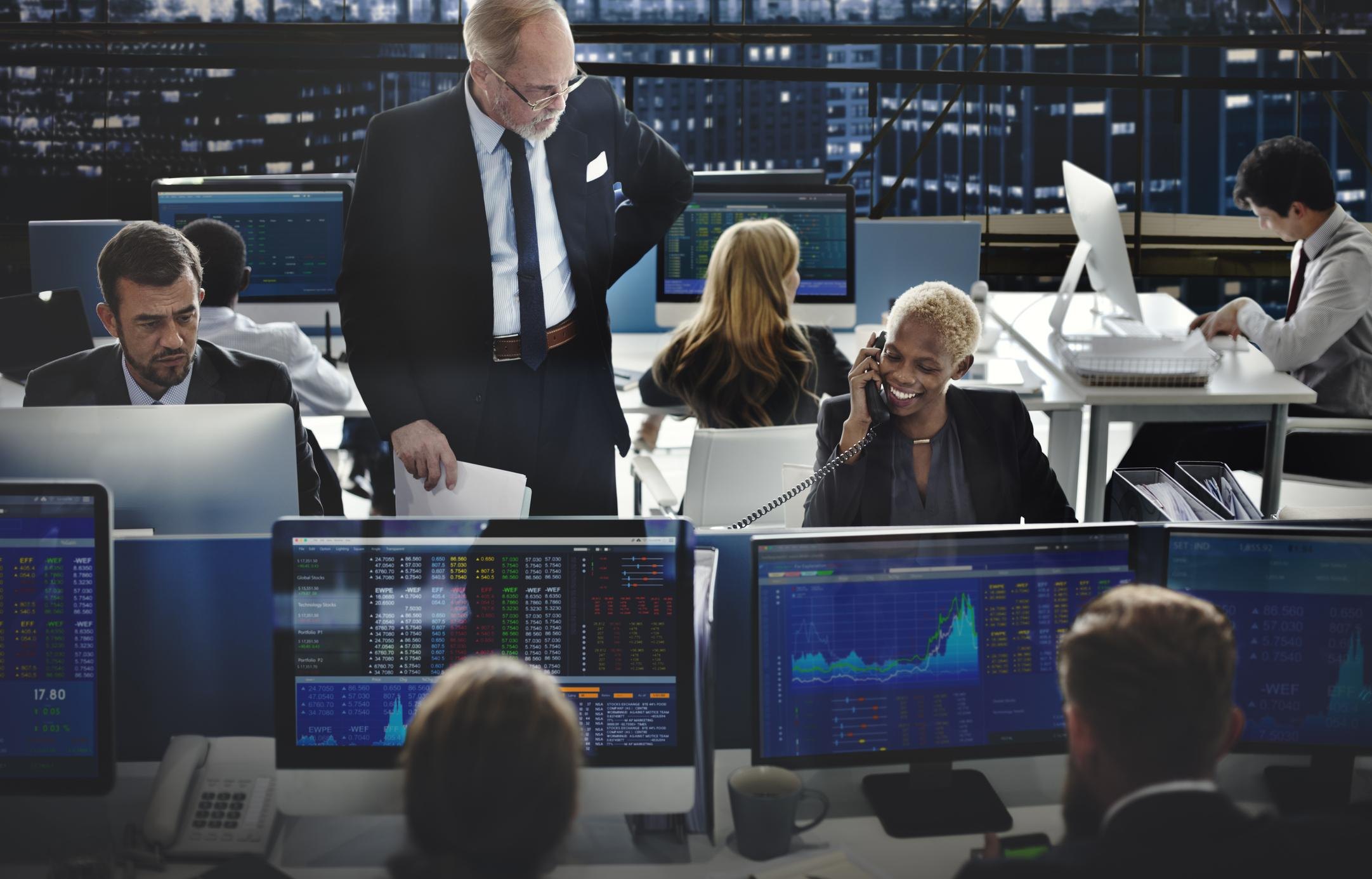 Professional trading floor with market dashboards and operators